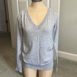 Gray V-neck women’s sweater.